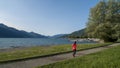 Jogger on the shore of Dongo, district of Gravedona, view over the lake como