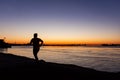 Jogger silhouette against sunrise on the Mississippi River Walk in New Orleans Royalty Free Stock Photo