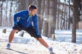 Jogger worming up legs after training Royalty Free Stock Photo