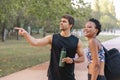 Joggers man and woman talking in park Royalty Free Stock Photo