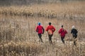 Joggers running through a field