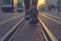 joggers running shoes on a city road with tram tracks