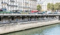 Joggers on the Seine path under the street at Place Saint Michel