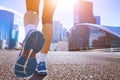 Jogging in the city, closeup of running shoes, active woman doing morning fitness workout in urban landscape, jogger legs, healthy