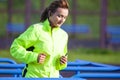 Professional Female Runner During Outdoor Training. Wearing Long Sleeve Jacket
