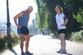 Jogging couple planning running route and setting music