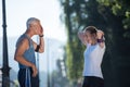 Jogging couple planning running route and setting music