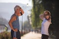 Jogging couple planning running route and setting music