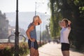 Jogging couple planning running route and setting music