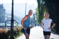 Jogging couple planning running route and setting music