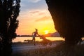 Jogging mother with stroller enjoying motherhood at sunset lands