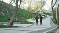 Jogging outdoors. Back view of a couple in black sportswear running together in the park. Morning cardio Royalty Free Stock Photo