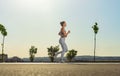 Jogging run. Strong athletic woman running on black background wearing in the sportswear. Fitness and sport motivation Royalty Free Stock Photo