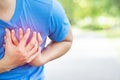 Jogging running athlete man having chest pain while exercising heart attack outdoor Heavy exercise causes the body to shock heart
