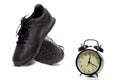 Jogging Sport Concepts. Pair of Black Trainers  Along with Clock Alarm in Foreground Royalty Free Stock Photo