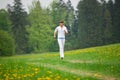 Jogging - sportive woman running in park