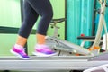 Jogging to lose weight to be healthy,legs wearing sneakers running on treadmill.