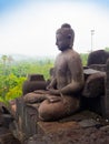 JOGJA, INDONESIA - AUGUST 12, 2O17: Close up of buddha statue and stupa at Borobudur Buddhist temple Candi Borobudur