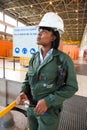 Female Technician in turbine room at Coal Burning Power Station