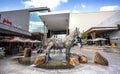 Entrance to mall with sculpture of animals in foreground. Royalty Free Stock Photo