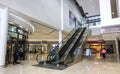 Interior to mall with escalator to upper level. Royalty Free Stock Photo