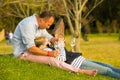 A couple relaxing on the grass at wine event