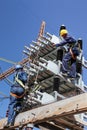 Electricians working on high voltage power lines