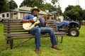 African Musician Kunle Ayo, Nigeria playing guitar on a farm