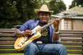 African Musician Kunle Ayo, Nigeria playing guitar on a farm