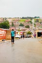 African people walking down a main road in Alexandra township, a formal and informal settlement