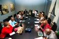 Diverse business persons going over data on digital devices at a meeting