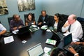 Diverse business persons going over data on digital devices