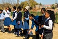 Diverse African high school pupils messing about on the sports field Royalty Free Stock Photo