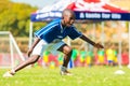 Diverse children playing soccer football at school