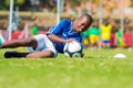 Diverse children playing soccer football at school