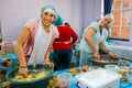 Soup Kitchen community outreach volunteers preparing meals for African children at orphanage Royalty Free Stock Photo