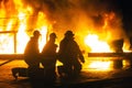 JOHANNESBURG, SOUTH AFRICA - MAY, 2018 Firefighters kneeling in front of burning structure during a fighting training exercise