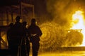 JOHANNESBURG, SOUTH AFRICA - MAY, 2018 Firefighters spraying water at burning tank during a firefighting training exercise Royalty Free Stock Photo