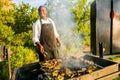 African man working a BBQ Grill in urban Soweto Royalty Free Stock Photo