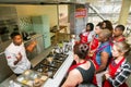 Diverse young people learning to cook and bake at a cooking class Royalty Free Stock Photo