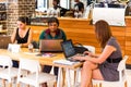 Diverse Female Customers using Internet in a Coffee Shop