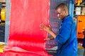 Diverse people working on an assembly line in a rubber factory