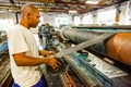 Diverse workers inside a rubber and pipe fabrication assembly line in a factory