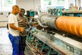 Diverse workers inside a rubber and pipe fabrication assembly line in a factory