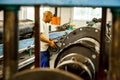 Diverse workers inside a rubber and pipe fabrication assembly line in a factory