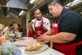 Diverse young people learning to cook and bake at a cooking class Royalty Free Stock Photo