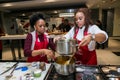 Young African women learning to cook and bake at a cooking class