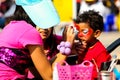 Young Indian child getting a Spiderman face paint mask at festival Royalty Free Stock Photo