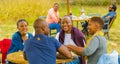 Two African couples laughing together at The Winter Sculpture Fair at Nirox Sculpture Park