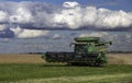 John Deer combine harvests a fall soybean crop